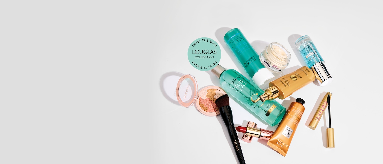 Una variedad de productos de belleza de Douglas, que incluyen maquillaje, cuidado de la piel y el cabello, se exhiben sobre un fondo blanco, con un sello verde que dice "DOUGLAS COLLECTION TRUST THE MINT".