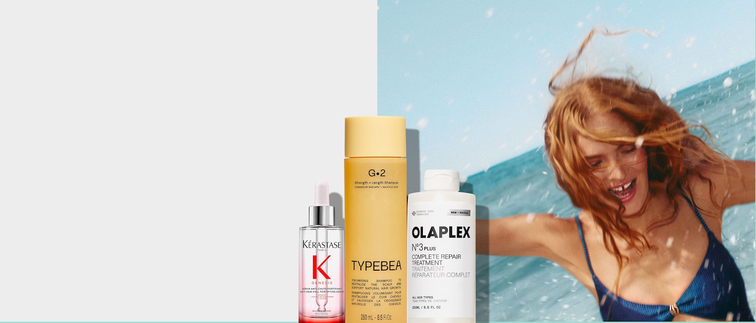 El sérum fortificante anticaída Kérastase Genesis en un frasco de cristal transparente con un aplicador de pipeta, con la marca Kérastase en rojo y negro.
