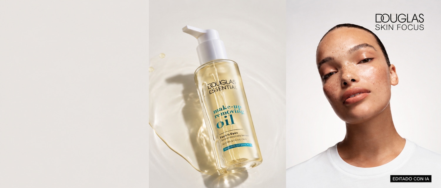 El aceite desmaquillante Douglas Essential, en un envase transparente con dosificador blanco, se presenta sobre una superficie clara con gotas de agua, destacando su textura ligera y su fórmula a base de aceites de jojoba y oliva.